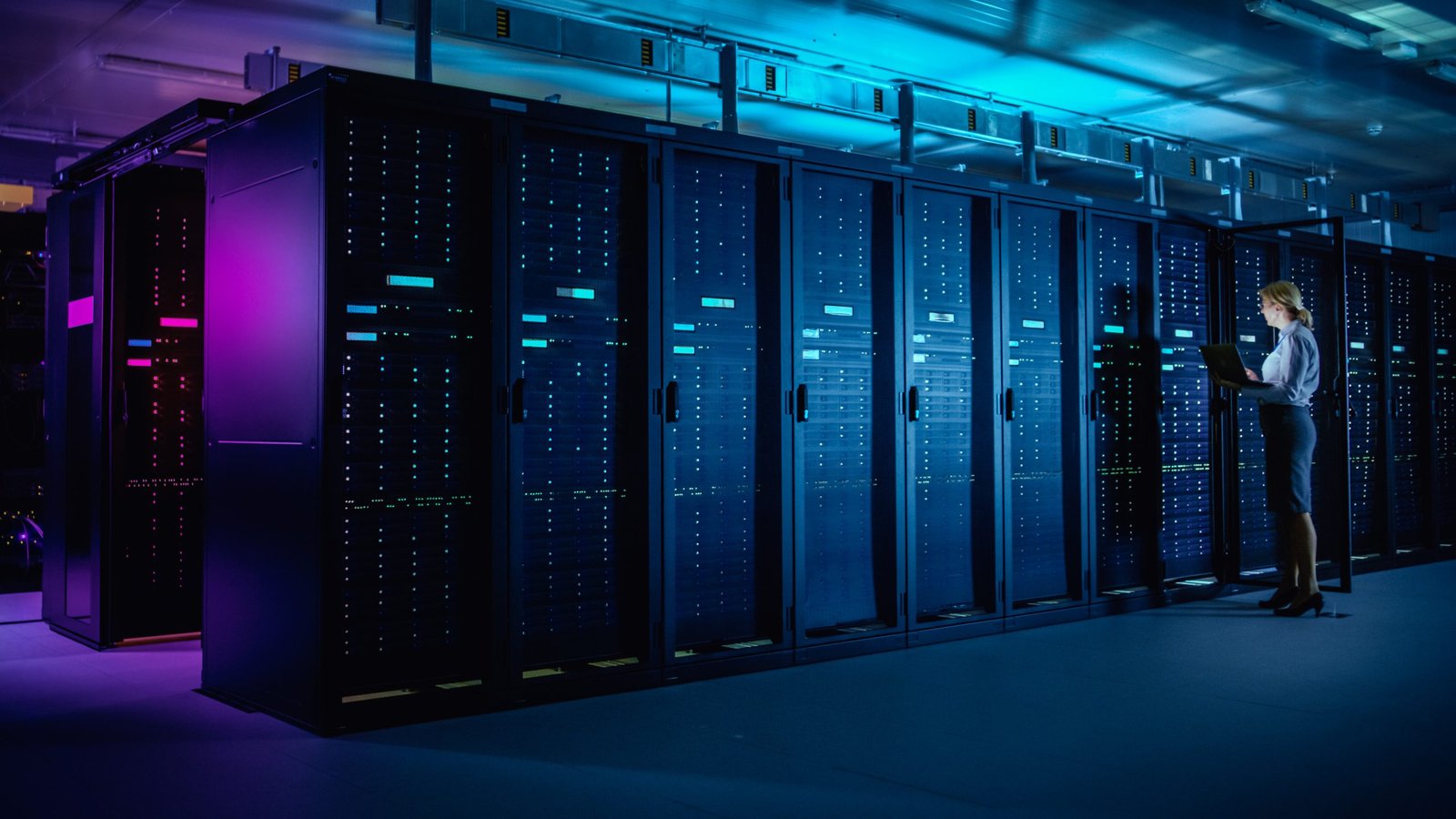 woman in server room in blue